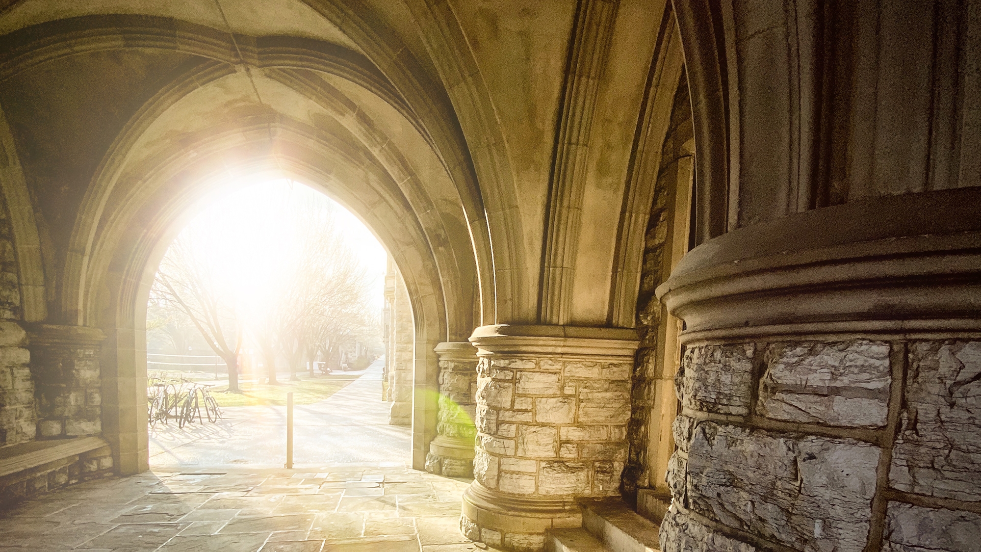 Sunlight though an archway on campus.